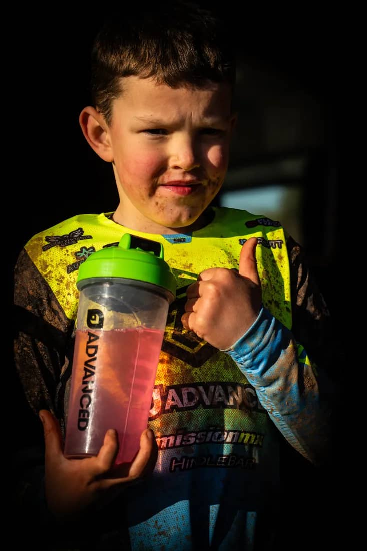 Henry Wilcox giving a thumbs up with his ADVANCED shaker after a muddy race