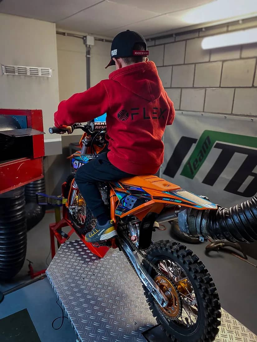 Henry Wilcox on his KTM 50 in the race trailer